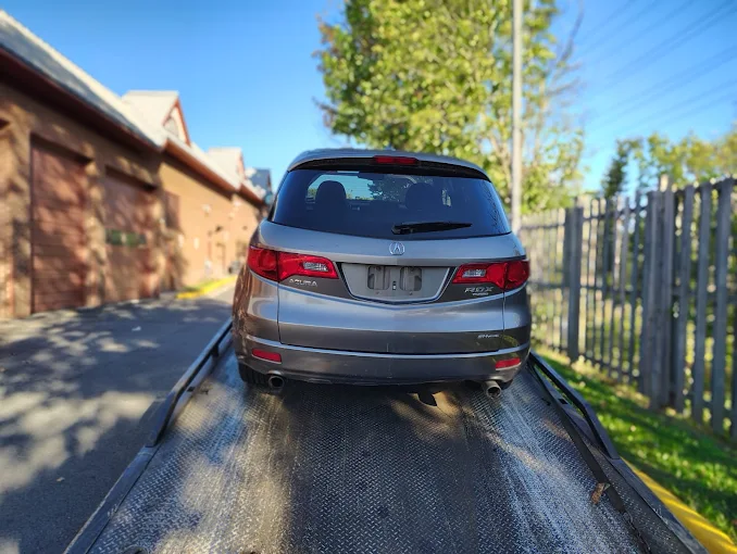 Acura RDX loaded on a flatbed for junk car removal in Arlington, VA