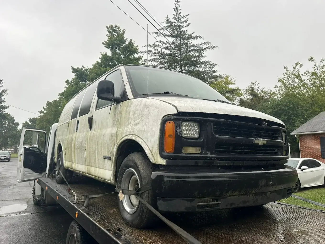 Chevrolet Express cargo van on a flatbed for junk van removal in Springfield, VA