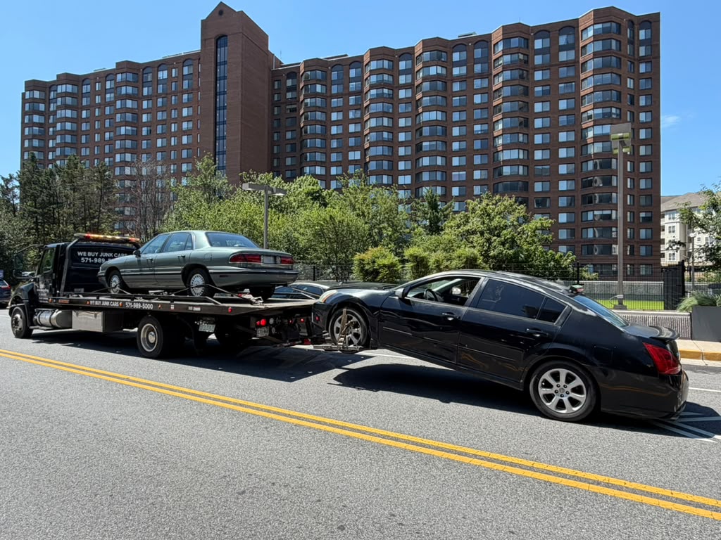 Damaged Infiniti loaded on a flatbed for junk car removal in Alexandria, VA