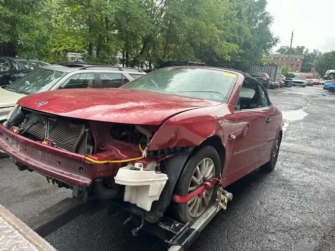 Damaged red Saab picked up for junk car removal in Annandale, VA